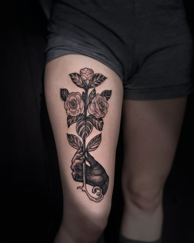 Hands and flowers tattoo by Adam LoRusso artist black and grey boston hand holding rose tattoo